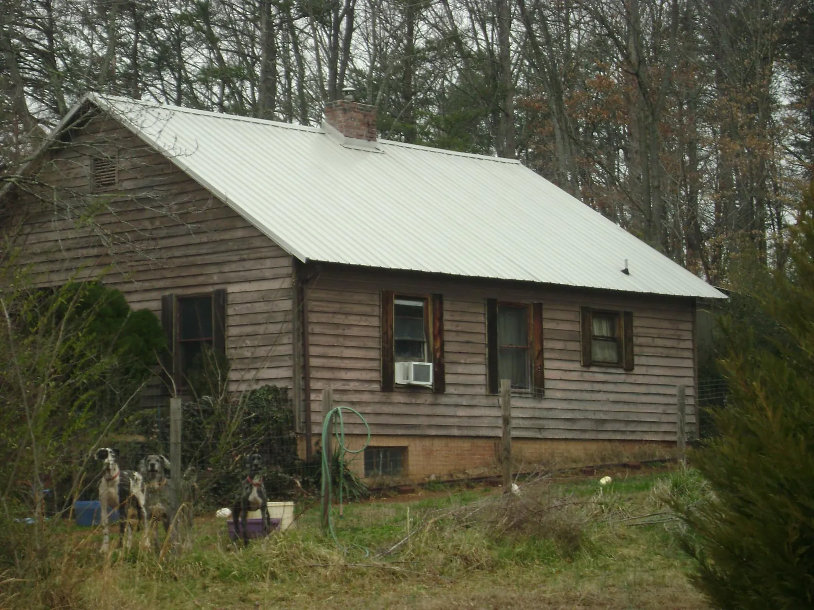 White metal roof on an old wood sided farmhouse, from a Metal Roof Installation job in Angola